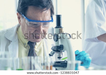 old man Scientist using microscope in laboratory Royalty-Free Stock Photo #1238831047