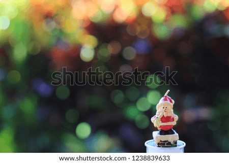 Candle Santa Claus Colorful bokeh is the background with copy space for text