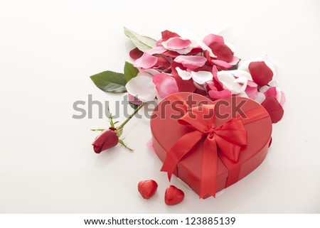 Valentines Day gift in red box with rose petal  isolated on white