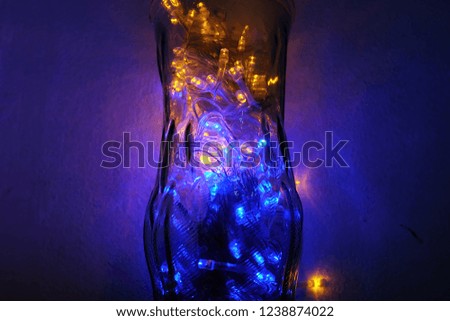 glass jar filled with fairy lights with low key
