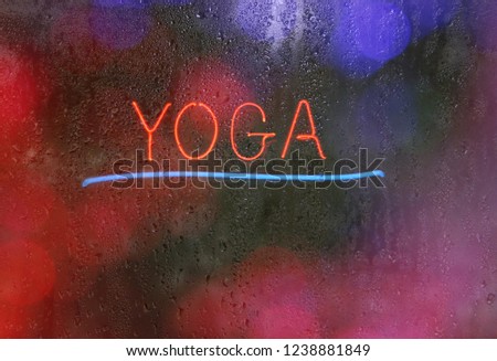 Neon Yoga Sign in Rainy Window