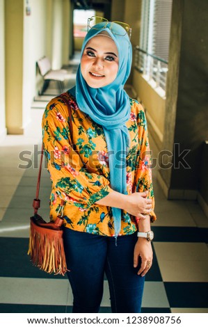 Young beautiful hijab wearing trendy fashion spectacles