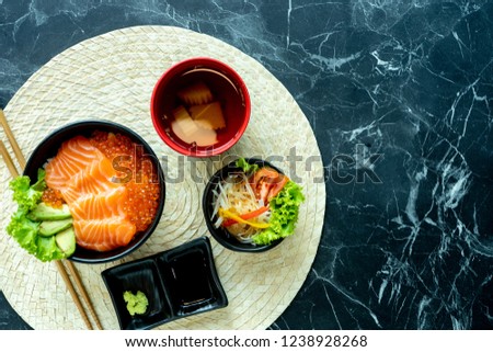 Japanese food mix on a  black stone table.top view composition. Salmon sashimi .