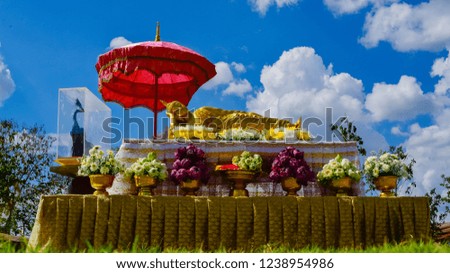 Statue of Sleeping Buddha with flower worship in Thai temple.