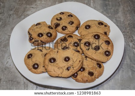 Chewy chocolate chip cookies on white plate