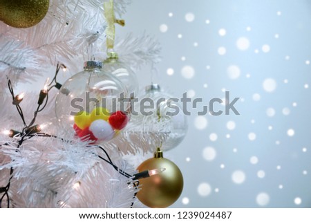Close up white christmas and pom poms ball on fir branches with bokeh background