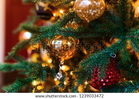 Merry Christmas and Happy New year Holidays! Decorating the Christmas tree indoors. Macro or close picture of xmas tree and gifts under it. Gift box background for 2019 new year gift card