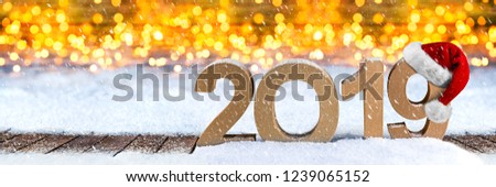 2019 happy new year christmas wide panorama greeting card number santa claus hat symbol lettering wooden snow background golden lights bokeh concept