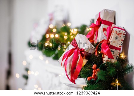 Beautiful Christmas room with garlands and decorated gifts on white fireplace. The idea for postcards. Place for text. Isolated. New Year celebration photo