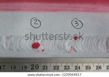 Defect colour red round indication and crack at butt weld carbon plate found by penetrant test.