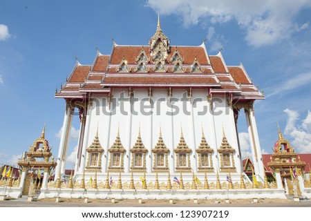 Colorful and ornate Thai Buddhist temple with beautiful blue sky background