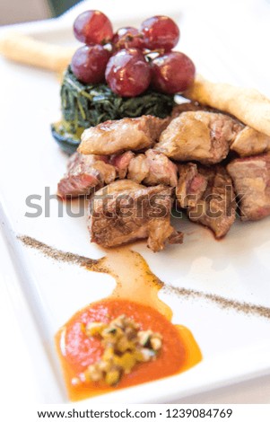 Meat and vegetables in a plate with fork and knife in a luxury restaurant in Rome, Lazio, Italy