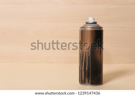Used can of spray paint on wooden background. Space for text