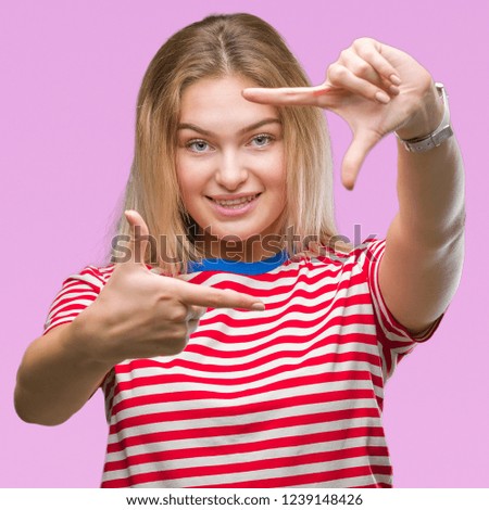 Young caucasian woman over isolated background smiling making frame with hands and fingers with happy face. Creativity and photography concept.