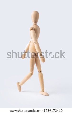 Business and design concept - walk wooden mannequin isolated on white background