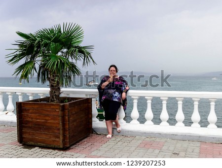 pictured in the photo a young girl on the seafront on a cloudy day
