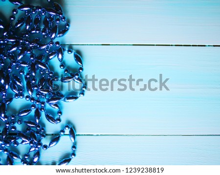 Christmas background with blue beads garlands. Copy space