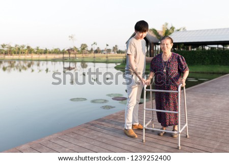 old patient use walker, old Asian female learning to use walker with care giver, walk training, family time, mother's day