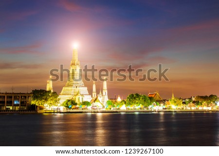 Wat Arun Buddhist Temple at sunset in bangkok Thailand. Wat Arun is among the best known of Thailand's landmarks. Temple Chao Phraya Riverside. The tourist like to take pictures and admire the beauty.