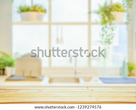 Wood table top on blurred kitchen background, Royalty-Free Stock Photo #1239274576