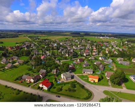 Aleksandrija village from drone flight, Small buildings from high with clouds , Lithuania country landscape