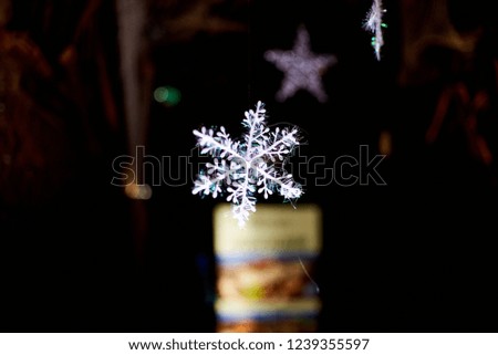 white snowflake on a background of lights