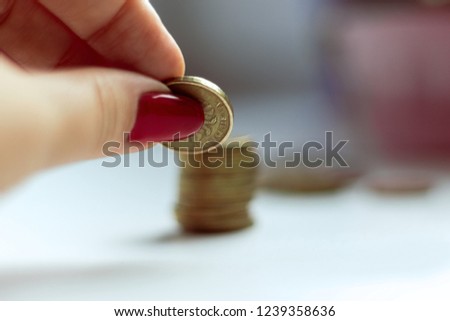 folding a tower of accumulated gold coins close-up