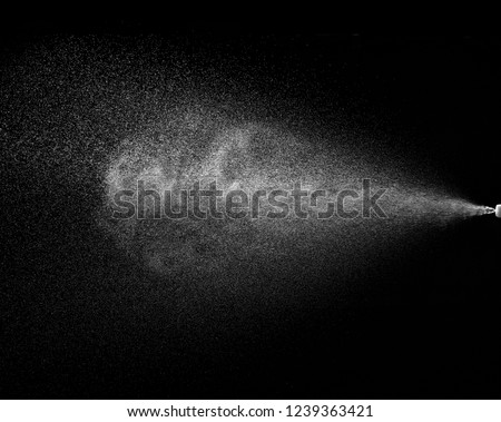 close up of spary water on black background Royalty-Free Stock Photo #1239363421