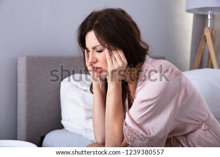 Side View Of A Young Woman Having Headache