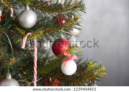 Christmas tree with red and white balls on gray background
