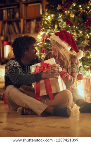 beautiful couple holding Christmas present