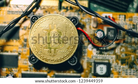 
Bitcoin cryptocurrency logo on the electronic board.