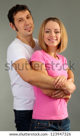 Loving couple on grey background