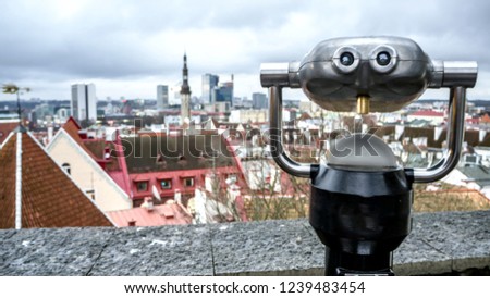 Coin Operated Telescope Binocular For Sightseeing At Town Tallinn Background Tallinn city in Estonia from the viewpoint. Toned picture, Copy space for your design. Autumn or  winter  season