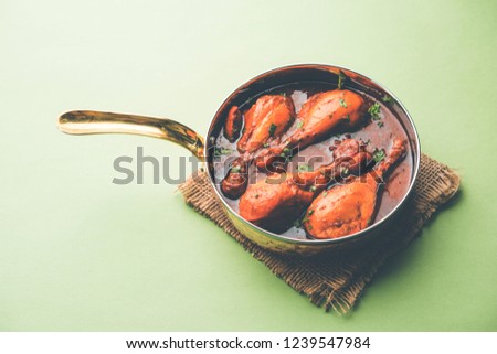 Chicken curry with legs/drumstick  or Murg Tangri/tangdi masala. Served in a bowl over moody background. Selective focus