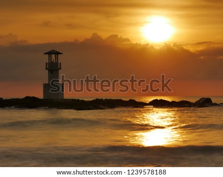 Image of sunset at Khao Lak Beach in Phang Nga,Thailand. English translate;Khao Lak light beacon, Hydrographic Department, Navy