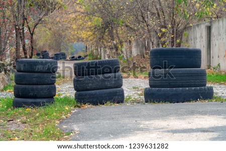 Barricades of tires on country road. Royalty-Free Stock Photo #1239631282