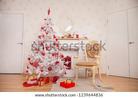 beautiful white christmas fir tree decorated room with fireplace and beige chair and knitted rug on the floor with nobody