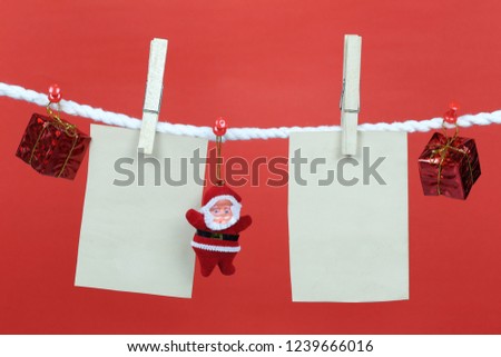 Empty note paper hang on the clothesline and have copy space with red background for design in your work concept.