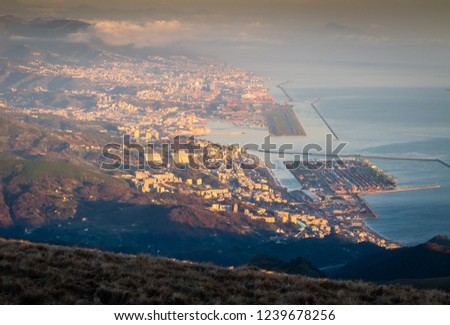 Genoa (Genova), Liguria, Italy: beautiful scenic aerial view of the city, port and airport Cristoforo Colombo runway at sunset. Cityscape photography.