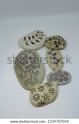 Hand-painted stones over white background