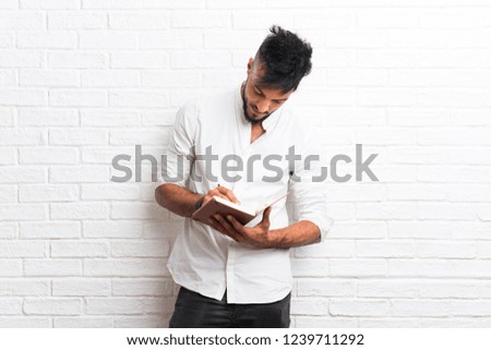 Arabic young man writing in a notebook