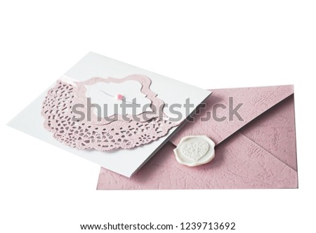 Isolated lace-decorated wedding invitation and a pink envelope with a wax stamp