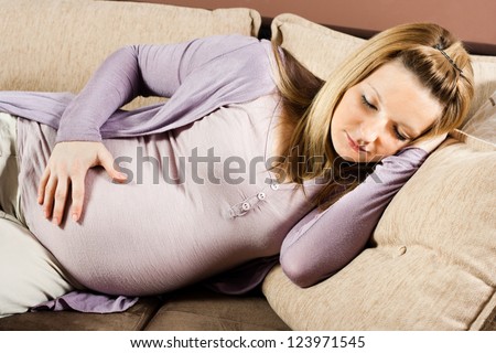 Pregnant woman is sleeping on sofa,Time for a nap Royalty-Free Stock Photo #123971545