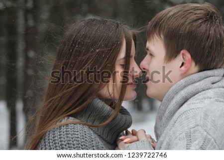 a pair of lovers on a date winter afternoon in a snow blizzard
