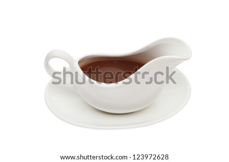 Gravy in a gravy boat isolated against white Royalty-Free Stock Photo #123972628