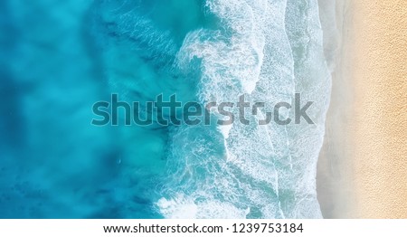 Beach and waves from top view. Turquoise water background from top view. Summer seascape from air. Top view from drone. Travel concept and idea Royalty-Free Stock Photo #1239753184