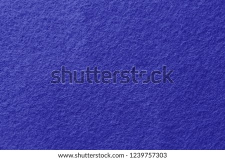Blue felt background. Surface of fabric texture.