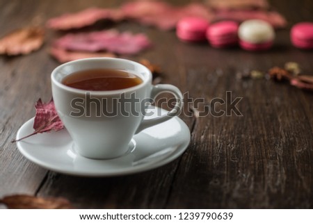 Autumn corner border with macaroon and hot drink. Table  scene on a rustic wood background. Copy space.