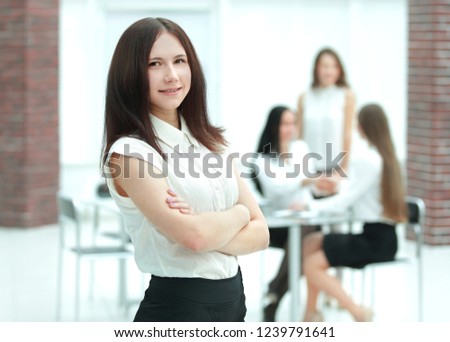 portrait of confident young business woman on office background